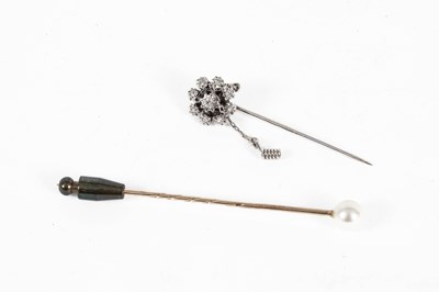 Lot 216 - A white metal and diamond cluster stick pin