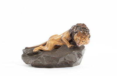 Lot 740 - A Royal Doulton prowling lion on a rock