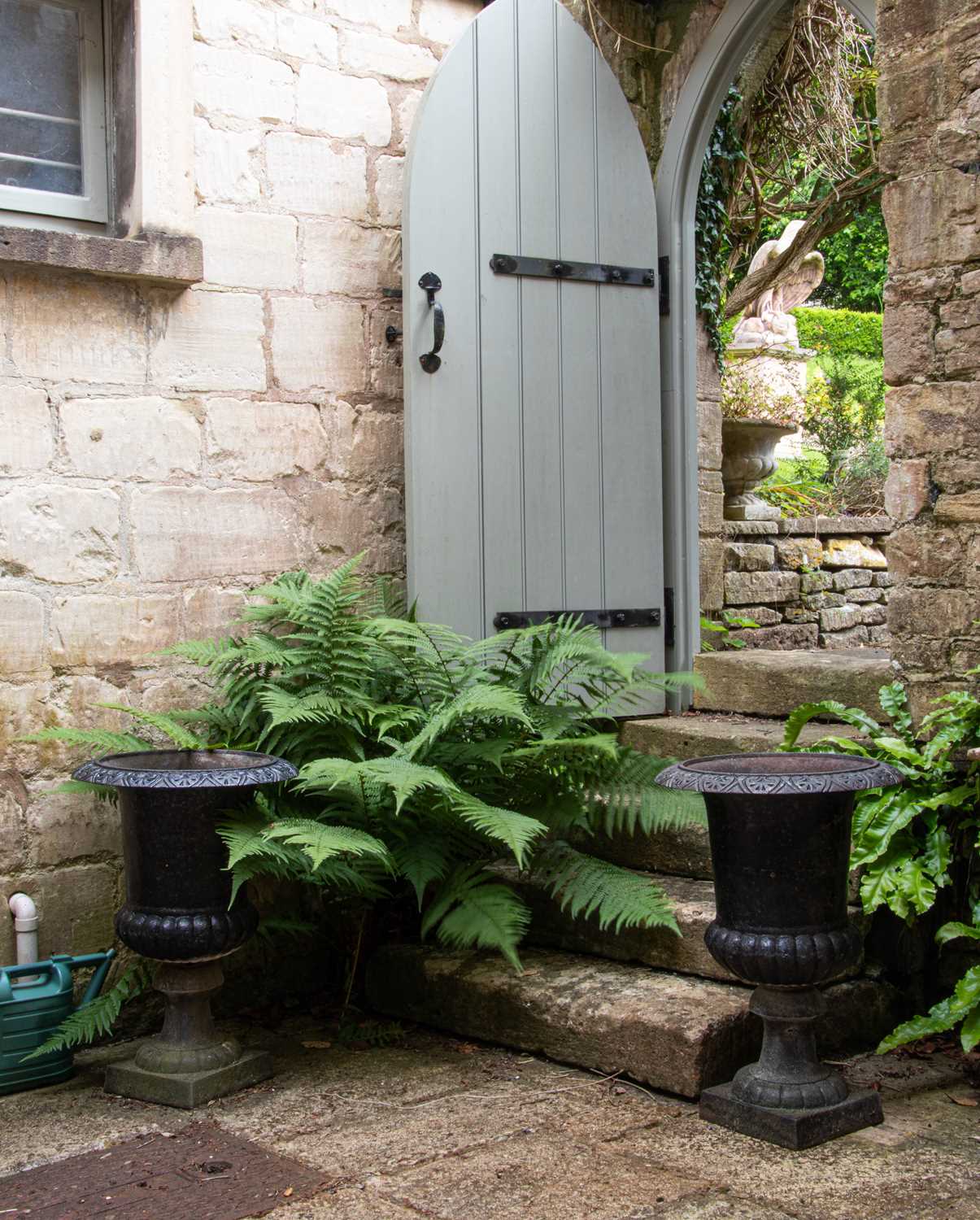 Lot 1 - A pair of cast iron urns