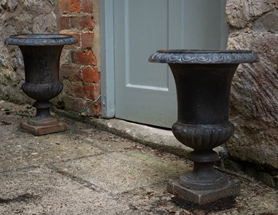 Lot 7 - A pair of small cast iron urns