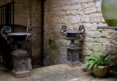 Lot 9 - A pair of twin-handled cast iron urns