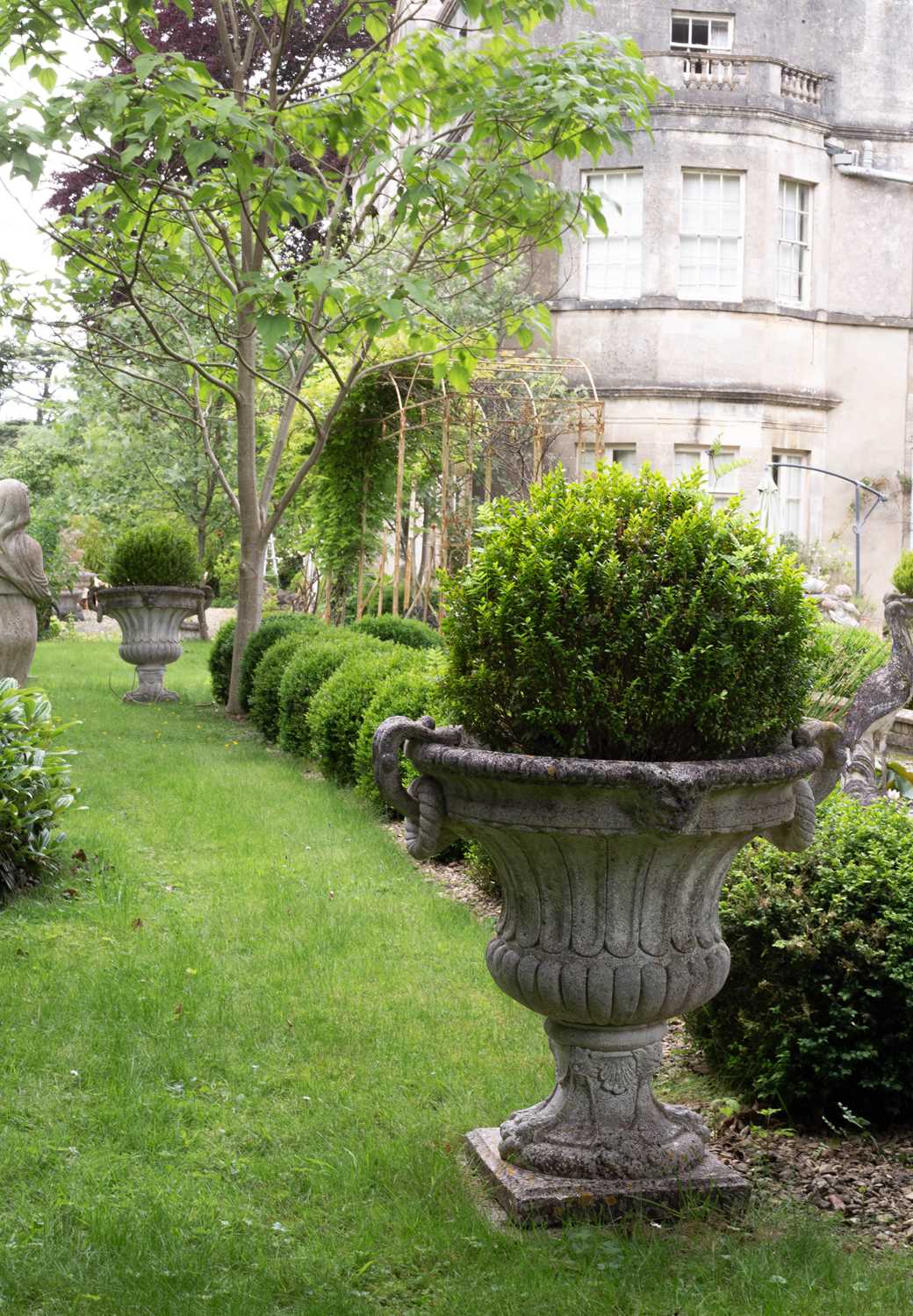 Lot 14 - A set of four campana-shaped reconstituted stone urns