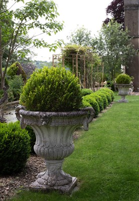 Lot 14 - A set of four campana-shaped reconstituted stone urns