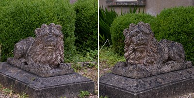 Lot 24 - A pair of Tritonstone reconstituted stone models of recumbent lions