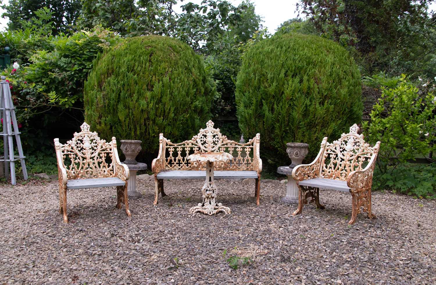 Lot 25 - A cast iron bench, two chairs and a table