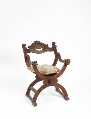 Lot 205 - A carved fruitwood Savonarola chair