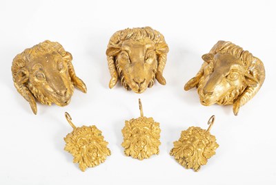 Lot 717 - Three carved giltwood ram's masks