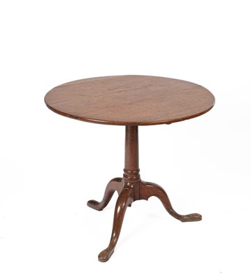 Lot 530 - A George III oak circular tilt top tripod table