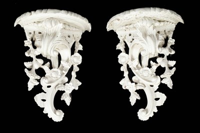 Lot 257 - A pair of Rococo style white painted wall brackets