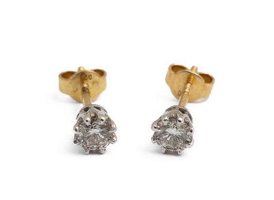 Lot 210 - A pair of 18ct gold and diamond solitaire stud earrings