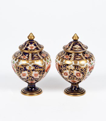 Lot 498 - A small pair of Royal Crown Derby Imari lidded vases