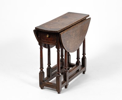 Lot 24 - A small George I oak gateleg table