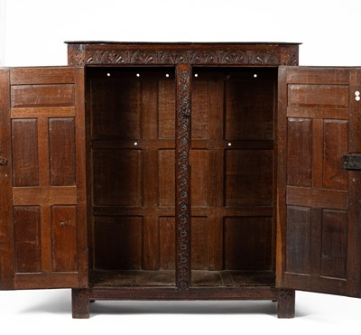 Lot 26 - A Charles II carved oak two door cupboard