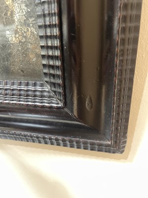 Lot 60 - A Dutch ebonised and ripple moulded mirror