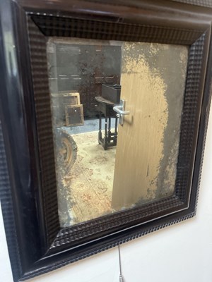 Lot 60 - A Dutch ebonised and ripple moulded mirror