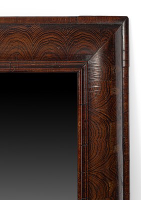 Lot 13 - A large William & Mary figured walnut cushion frame mirror