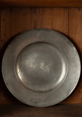 Lot 113 - An English pewter broad rim charger