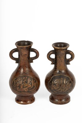 Lot 589 - A near pair of Arabic inscribed bronze baluster vases