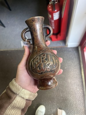 Lot 589 - A near pair of Arabic inscribed bronze baluster vases