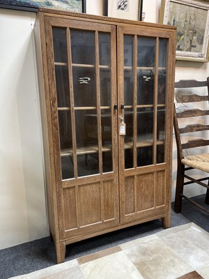 Lot 577 - An Arts & Crafts style limed oak bookcase