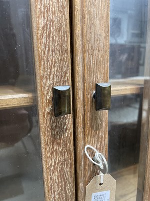 Lot 577 - An Arts & Crafts style limed oak bookcase