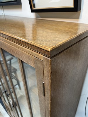 Lot 577 - An Arts & Crafts style limed oak bookcase