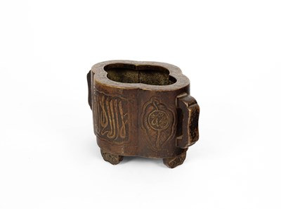 Lot 572 - An Arabic inscribed quatrefoil-shaped bronze incense burner