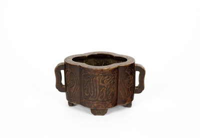 Lot 572 - An Arabic inscribed quatrefoil-shaped bronze incense burner