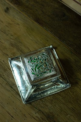 Lot An Arts & Crafts silver and green enamel inkstand