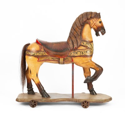 Lot 570 - A carved and painted ride-on horse