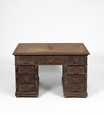 Lot 415 - A Medieval Revival carved oak pedestal desk