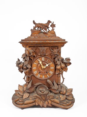 Lot 447 - A 19th Century South German carved walnut musical cuckoo clock