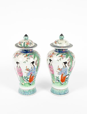 Lot 521 - A pair of Chinese famille rose baluster vases and covers