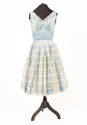 Lot 646 - A 1950/60s blue chiffon check dress with bow back