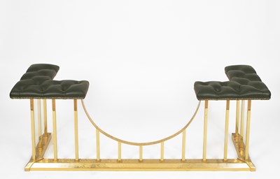 Lot 679 - A brass and leather upholstered club fender