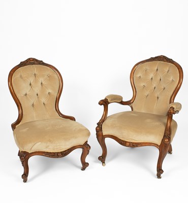 Lot 719 - A near pair of Victorian walnut framed fireside chairs