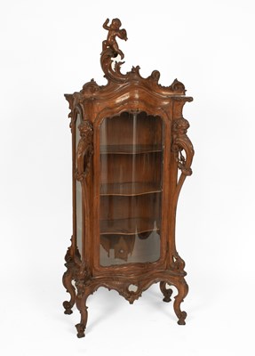 Lot 727 - An Italian Baroque-style carved walnut display cabinet