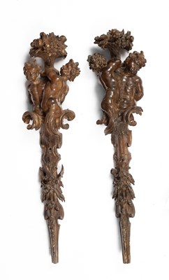 Lot 785 - A pair of carved limewood wall appliques