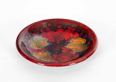 Lot 406 - A Moorcroft leaves and berries pattern flambe dish