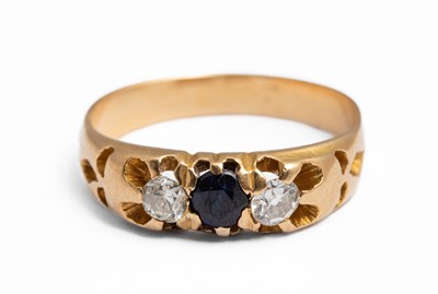 Lot 148 - A yellow gold sapphire and diamond three stone ring