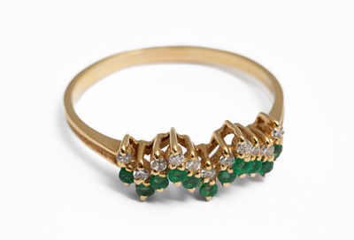 Lot 157 - A yellow metal emerald and diamond ring