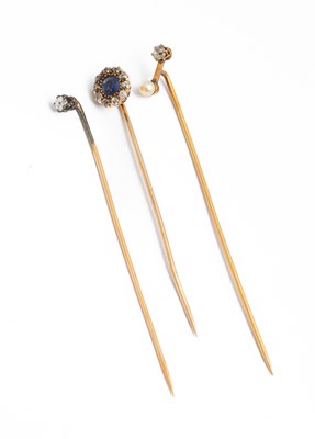 Lot 193 - Three yellow metal gem set stick pins