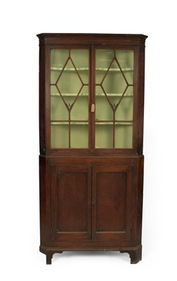 Lot 362 - A George III mahogany floor standing corner cupboard