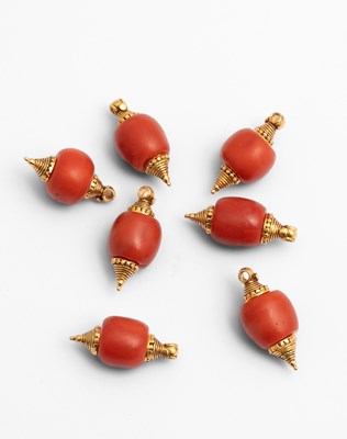 Lot 239 - A group of seven large coral beads with gold mounts