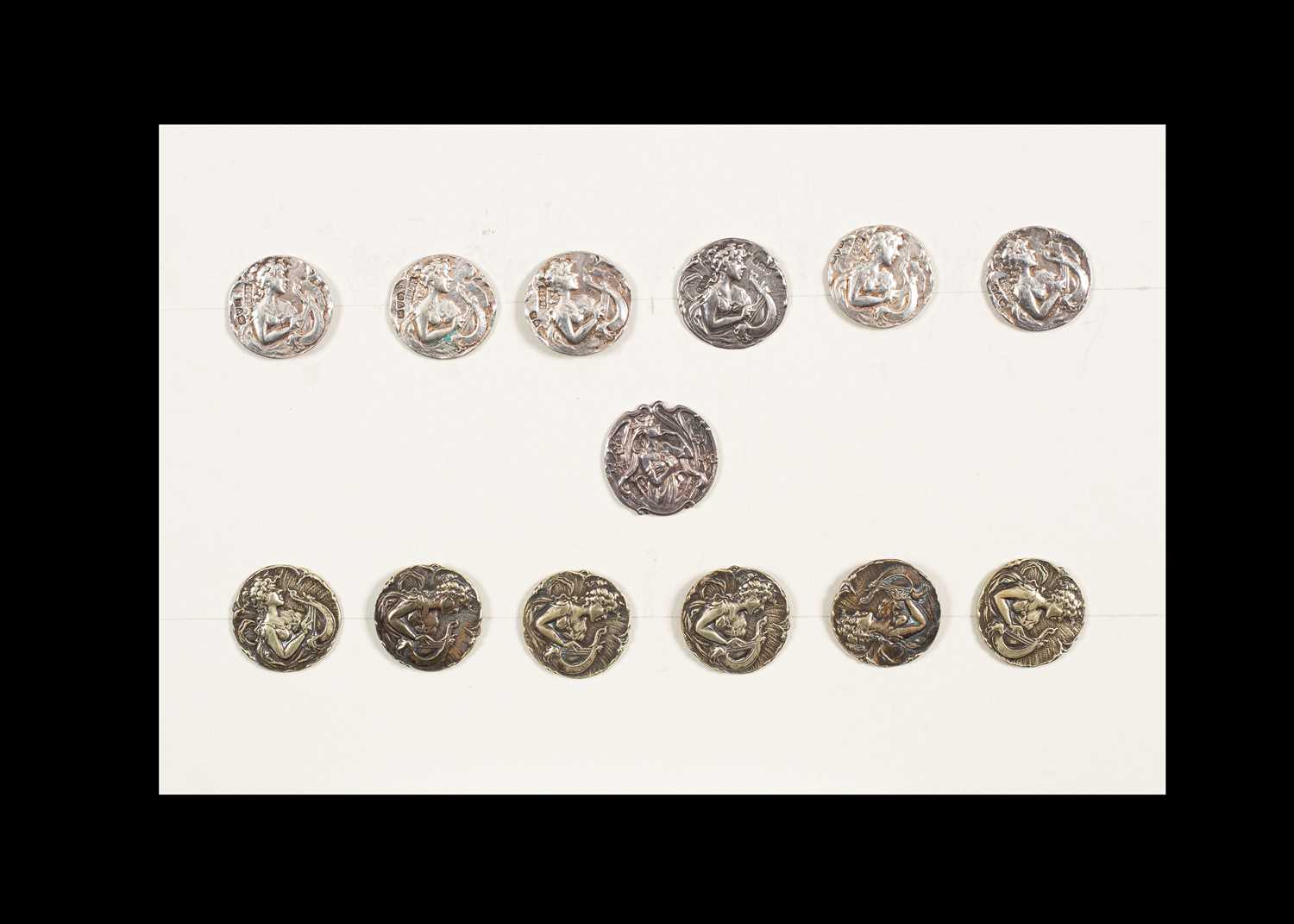 Lot 202 - A group of thirteen buttons with female heads