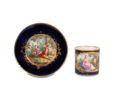 Lot 522 - A Sèvres style dark blue ground cup and saucer