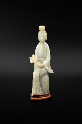 Lot 586 - A celadon jade figure of Guanyin