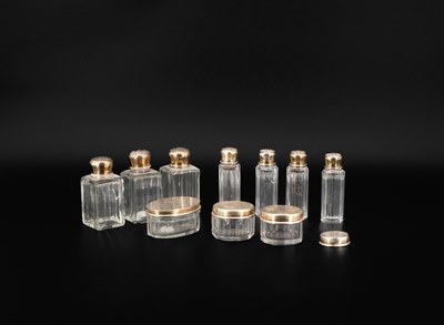 Lot 36 - A small group of American Sterling silver-mounted scent bottles and jars