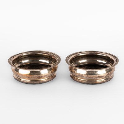 Lot 57 - A pair of circular silver wine coasters