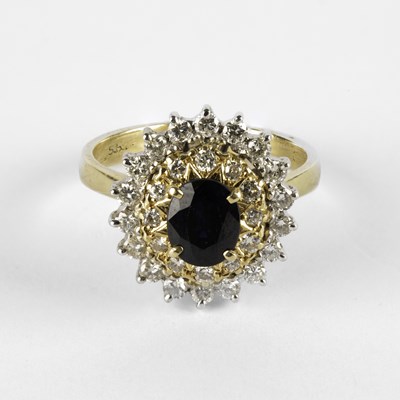 Lot 305 - A blue stone and diamond oval cluster ring